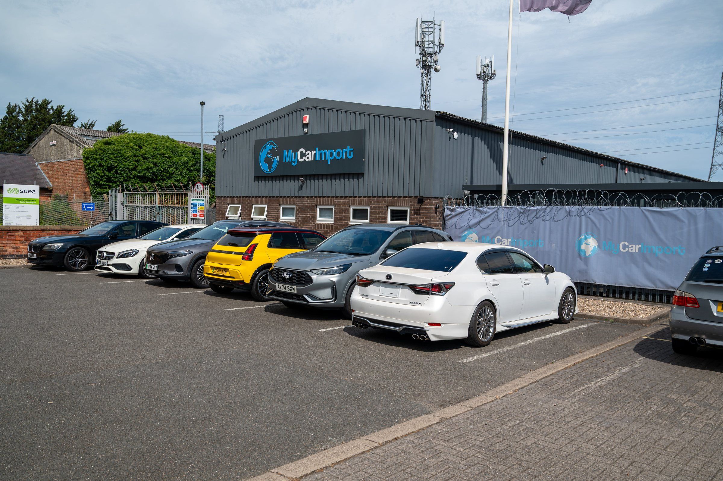 The My Car Import unit at Castle Donington, with imported cars parked in front of it
