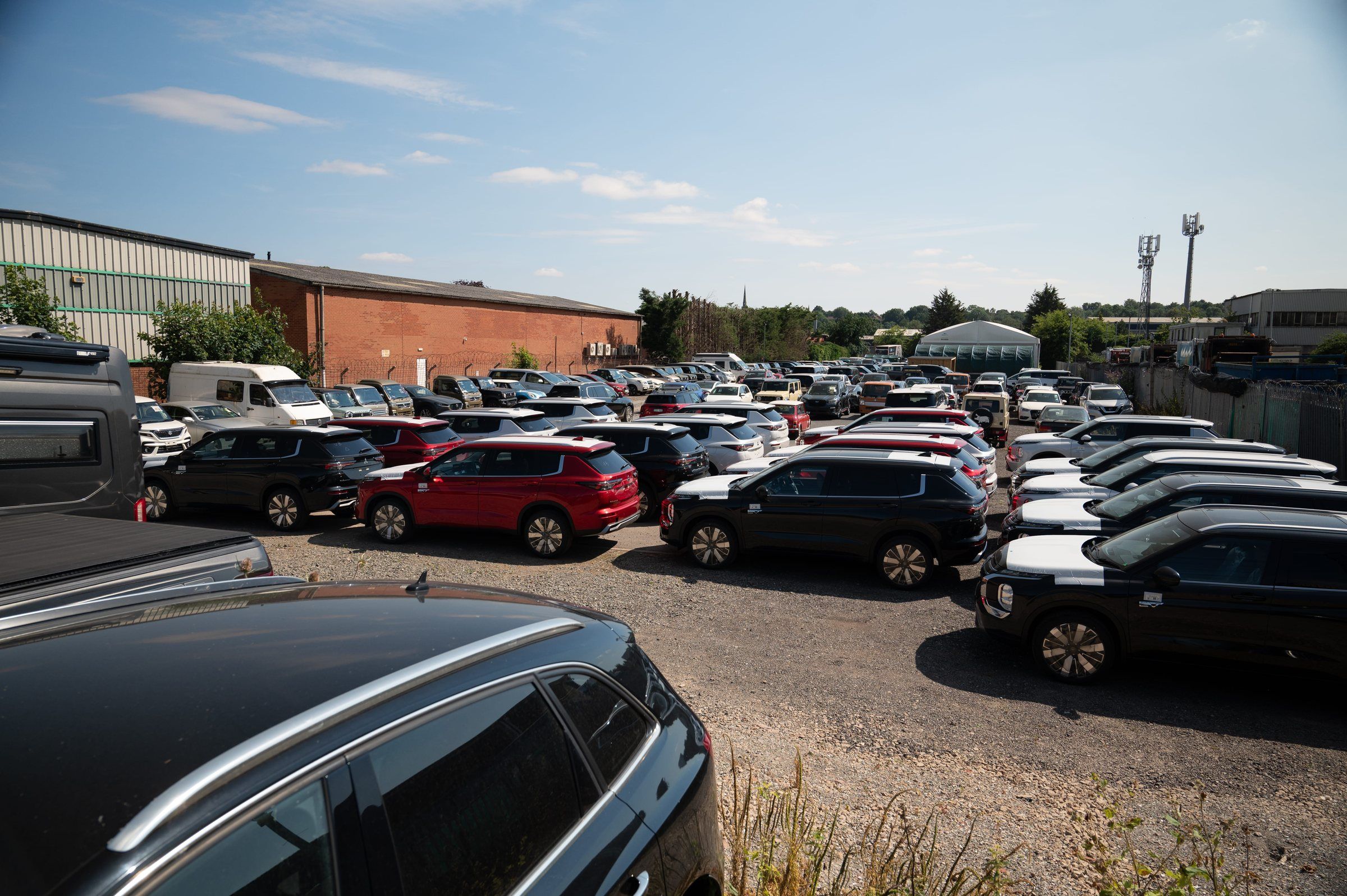 An elevated view across the My Car Import yard, with rows of imported cars parked closely together